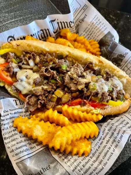 A loaded cheesesteak with waffle fries